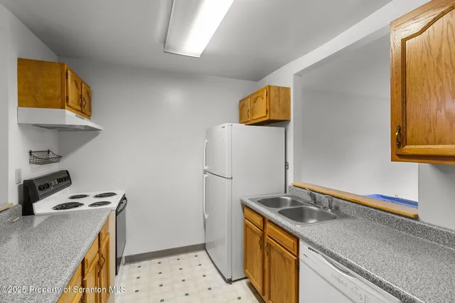 a living room with lots of furniture and a kitchen