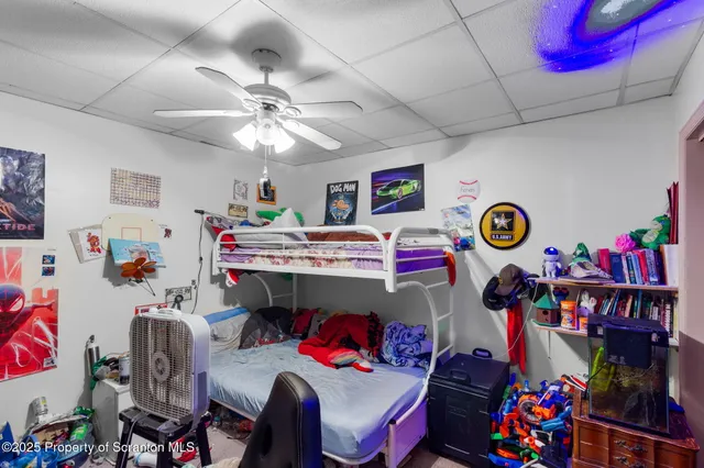 a living room with furniture gym equipment and a flat screen tv