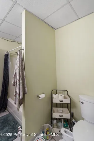 a view of a backyard with plants and brick wall