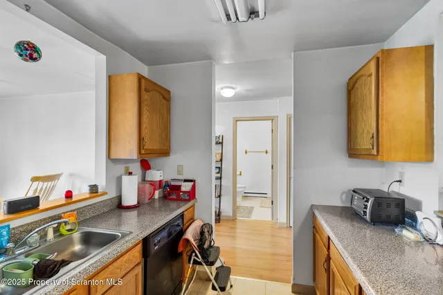 a living room with furniture a flat screen tv and a window
