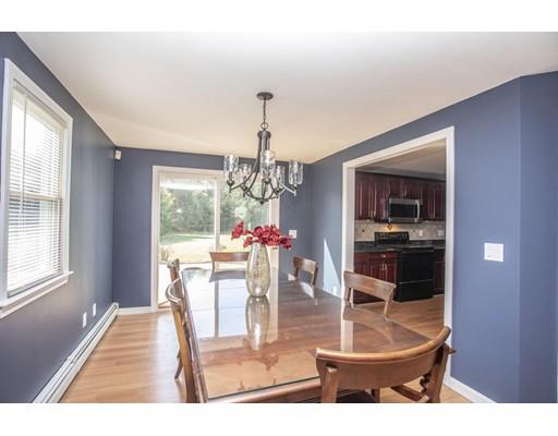 6 Wallace Drive Berkley, MA 02779 - Photo 8 of 30 a dining room with wooden floor a chandelier a glass table and chairs