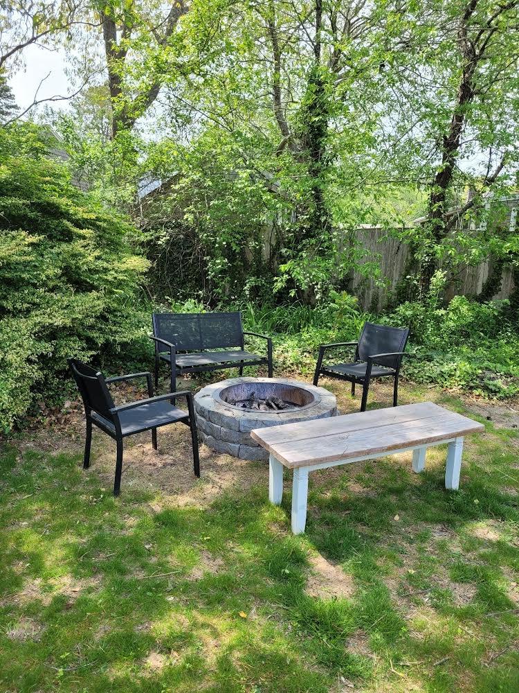 52 Ploughed Neck Road East Sandwich, MA 02537 - Photo 20 of 20 a wooden bench sitting in the middle of a yard