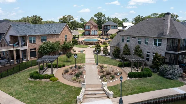 an aerial view of a house with outdoor space and lake view