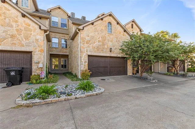a view of a house with a yard and garage