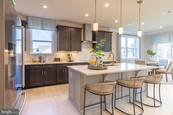 a kitchen with a refrigerator a sink dishwasher a stove and a oven with wooden floor