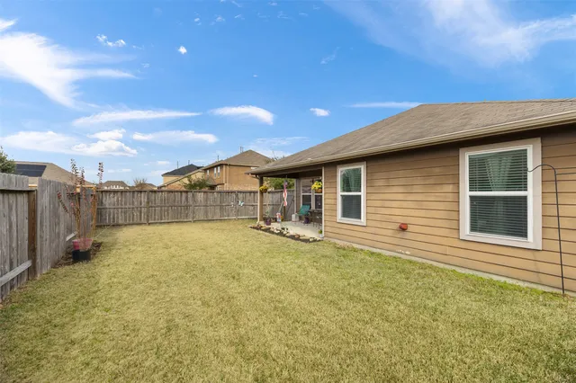 a view of an house with backyard and sitting area