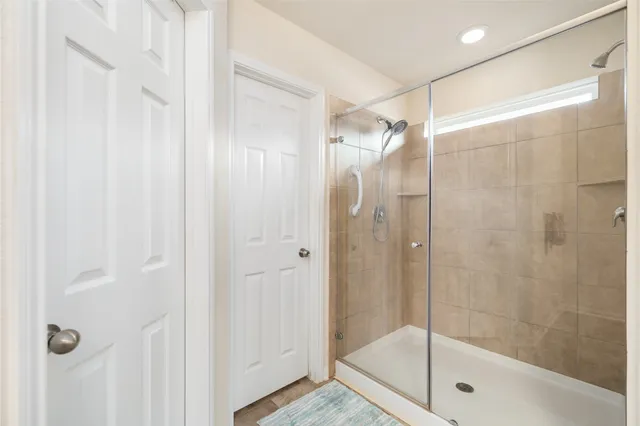 a bathroom with a glass shower door
