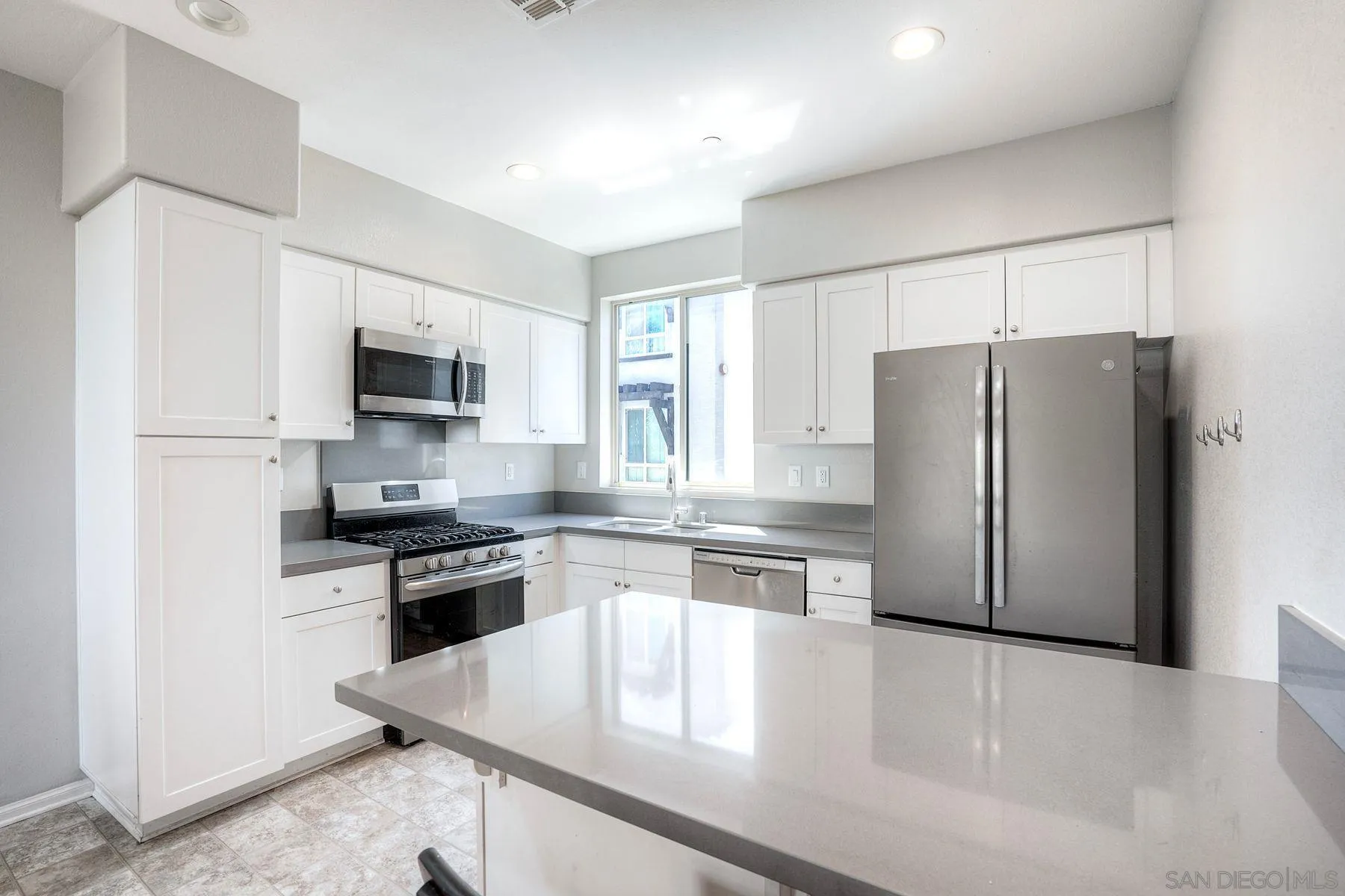 8850 Olive Lane, Unit 7 Santee, CA 92071 - Photo 2 of 27 a kitchen with stainless steel appliances granite countertop a refrigerator stove top oven and sink
