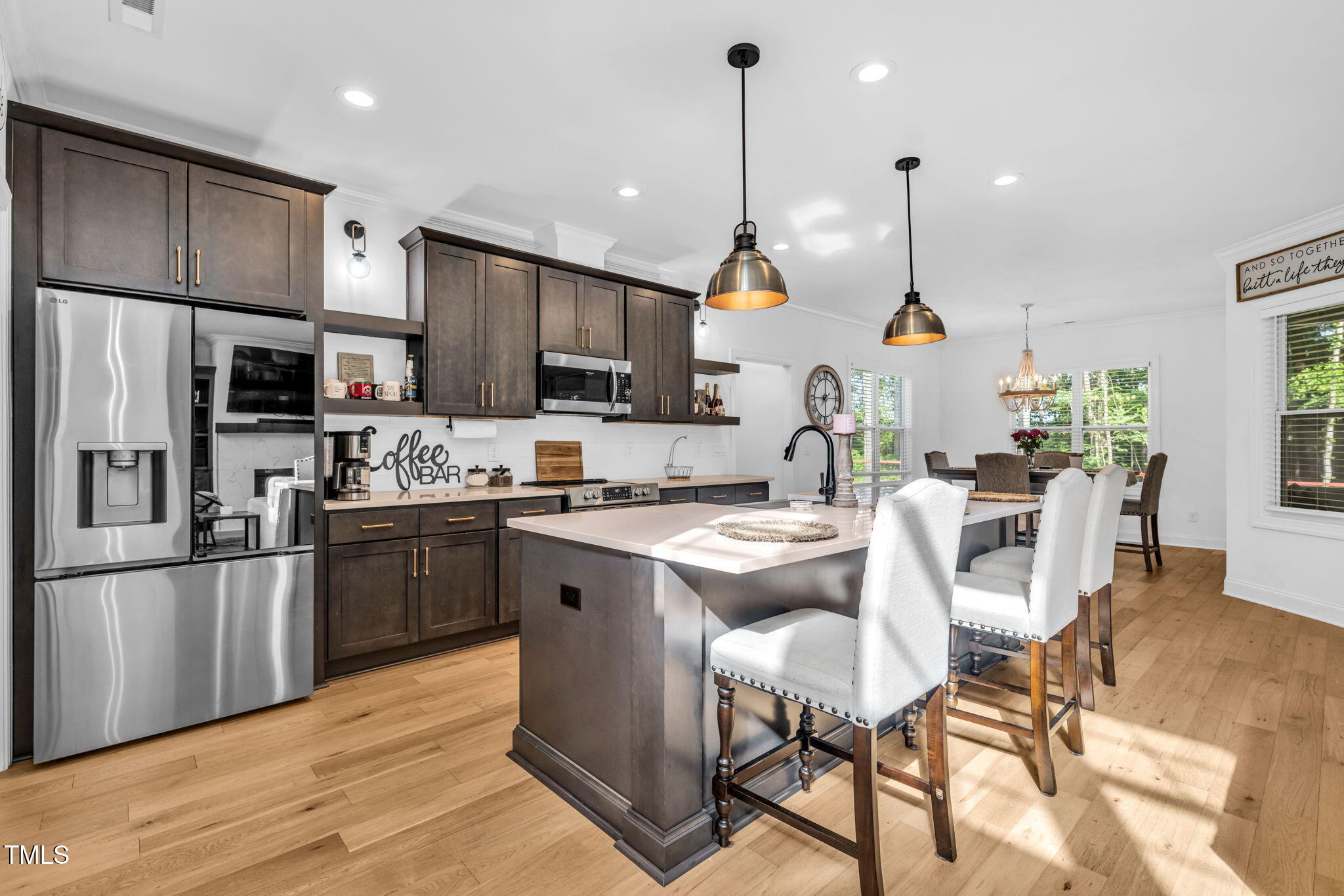 45 Tamaran Ct Spring Spring Hope, NC 27882 - Photo 9 of 35 a kitchen with stainless steel appliances kitchen island granite countertop a refrigerator a stove a sink a island and chairs with wooden floor