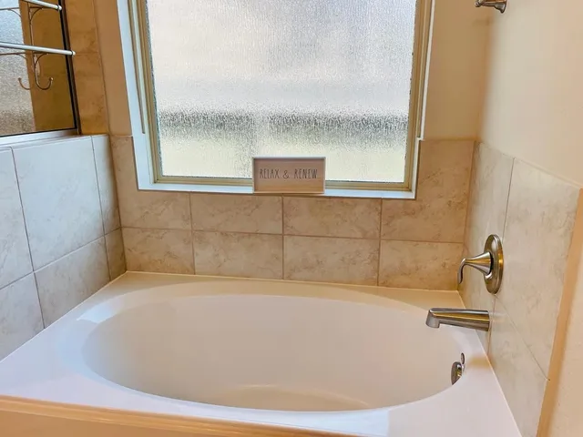 a bathroom with a bathtub and shower