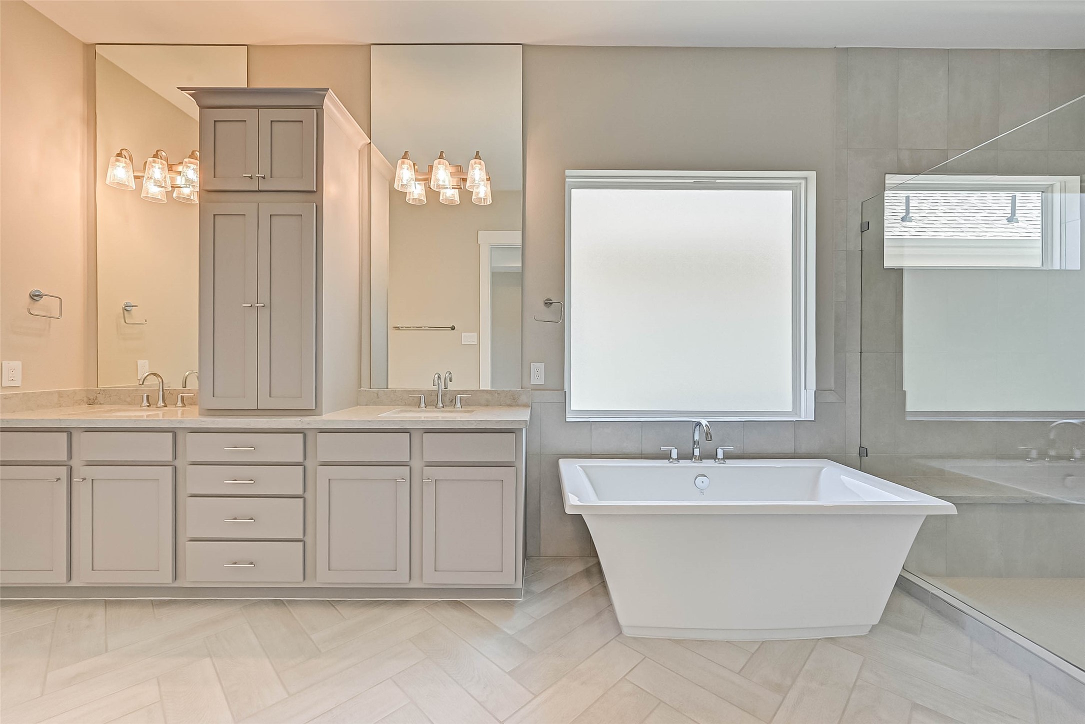 67 Thorpe Lane Spring, TX 77389 - Photo 19 of 27 a bathroom with a tub a double vanity sink and a mirror