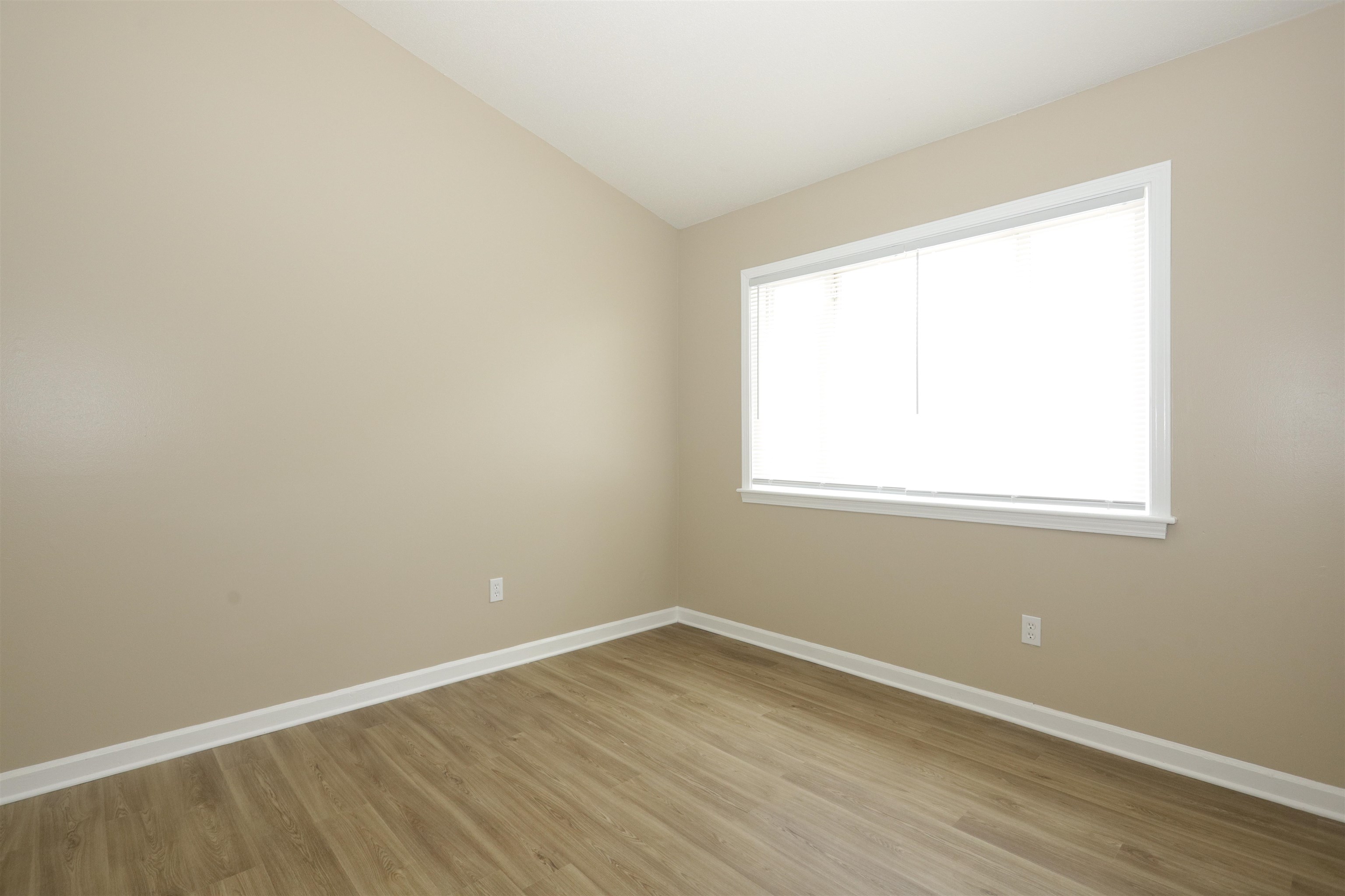 5142 Fairley Road Memphis, TN 38109 - Photo 11 of 13 an empty room with wooden floor and windows
