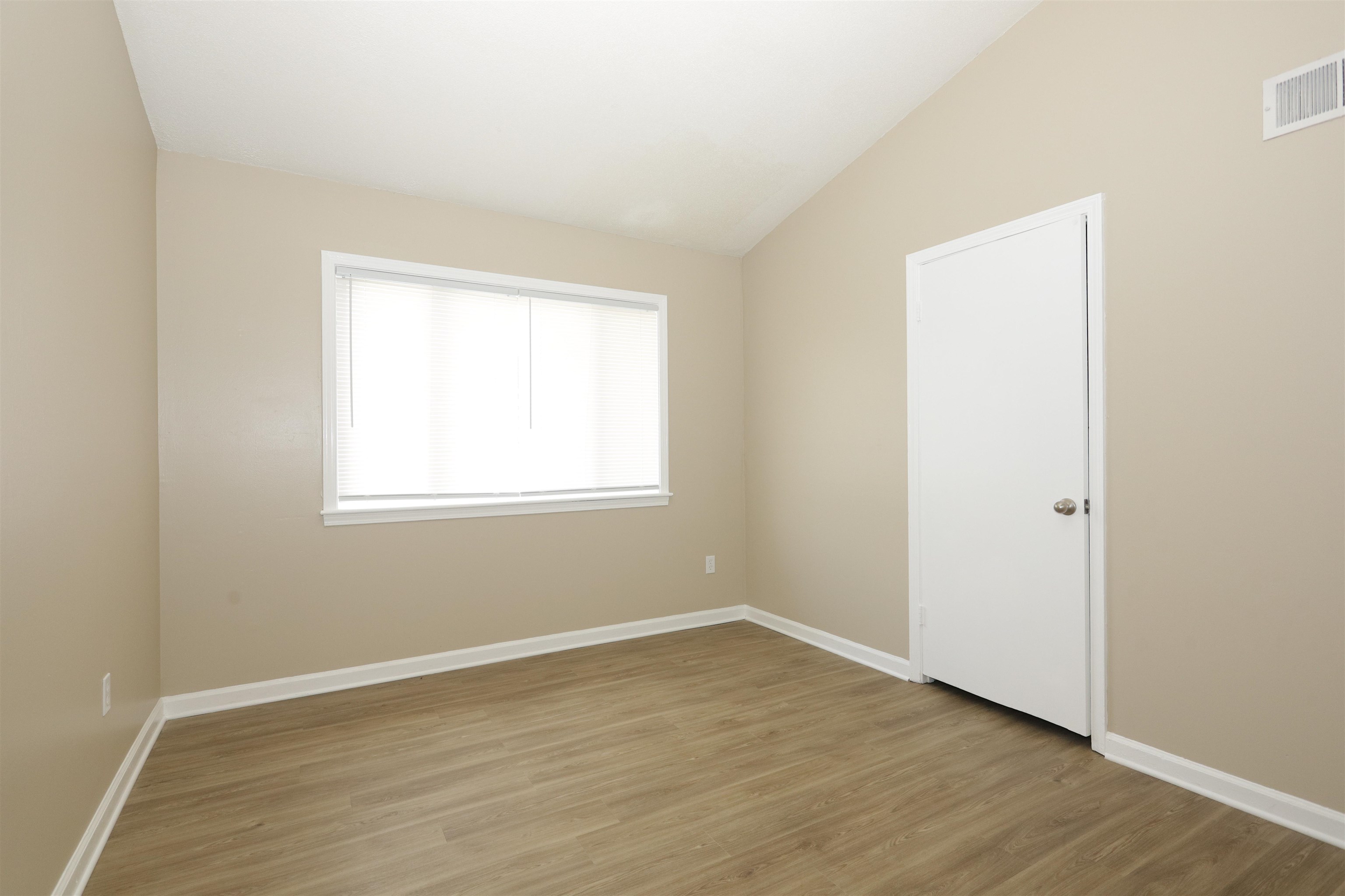 5142 Fairley Road Memphis, TN 38109 - Photo 13 of 13 an empty room with wooden floor and windows