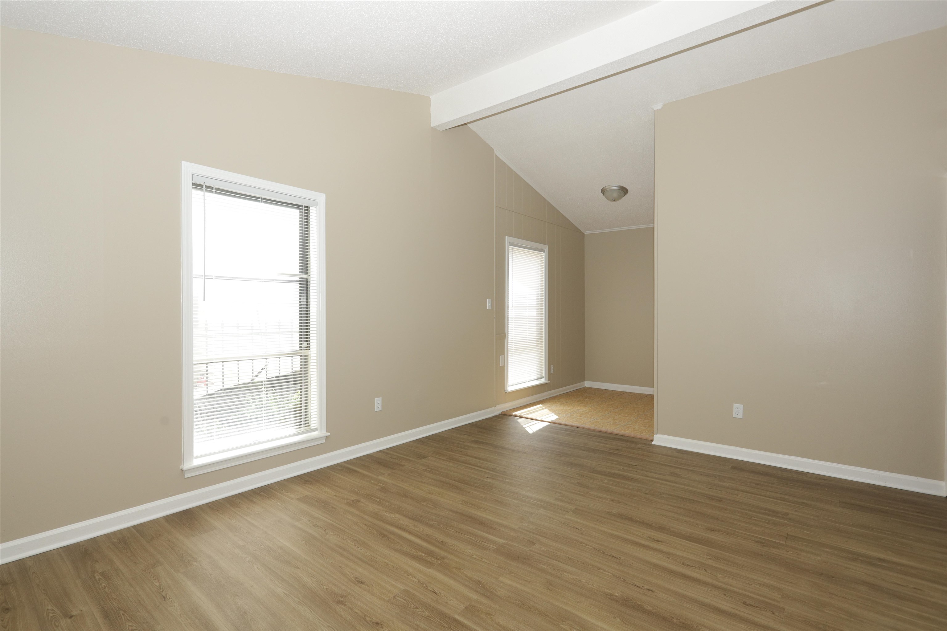 5142 Fairley Road Memphis, TN 38109 - Photo 4 of 13 a view of an empty room with wooden floor and a window