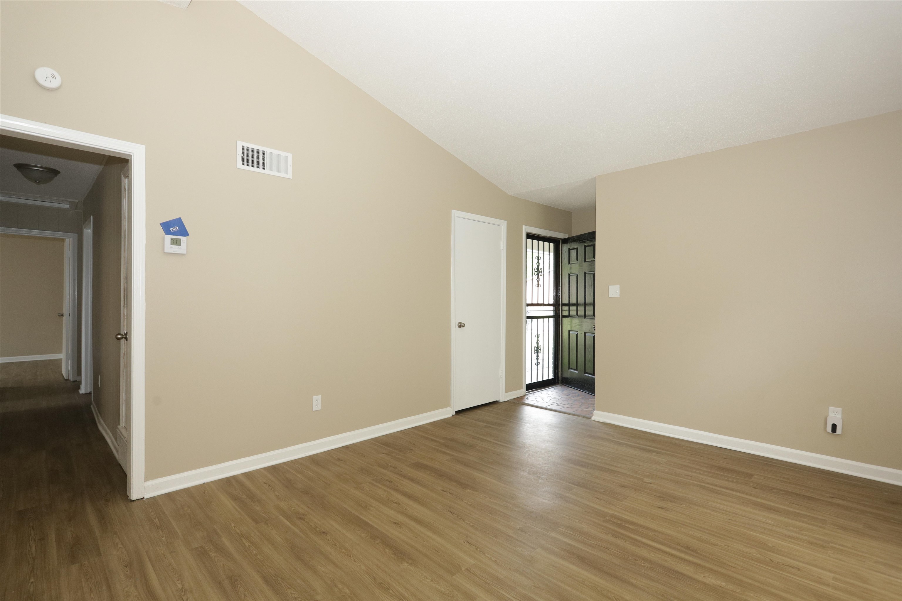 5142 Fairley Road Memphis, TN 38109 - Photo 5 of 13 a view of an empty room with wooden floor and a window