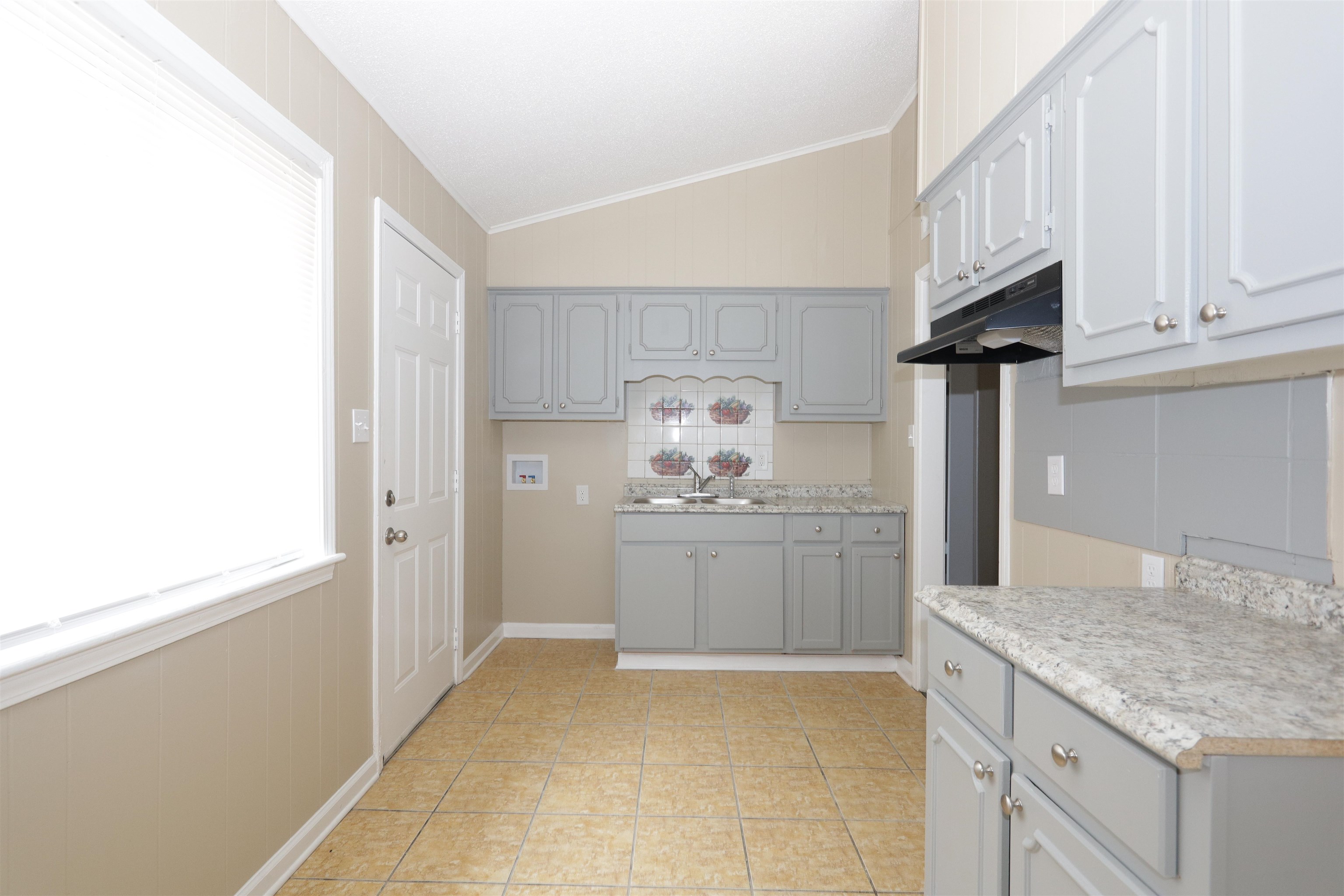 5142 Fairley Road Memphis, TN 38109 - Photo 7 of 13 a kitchen with granite countertop white cabinets and sink