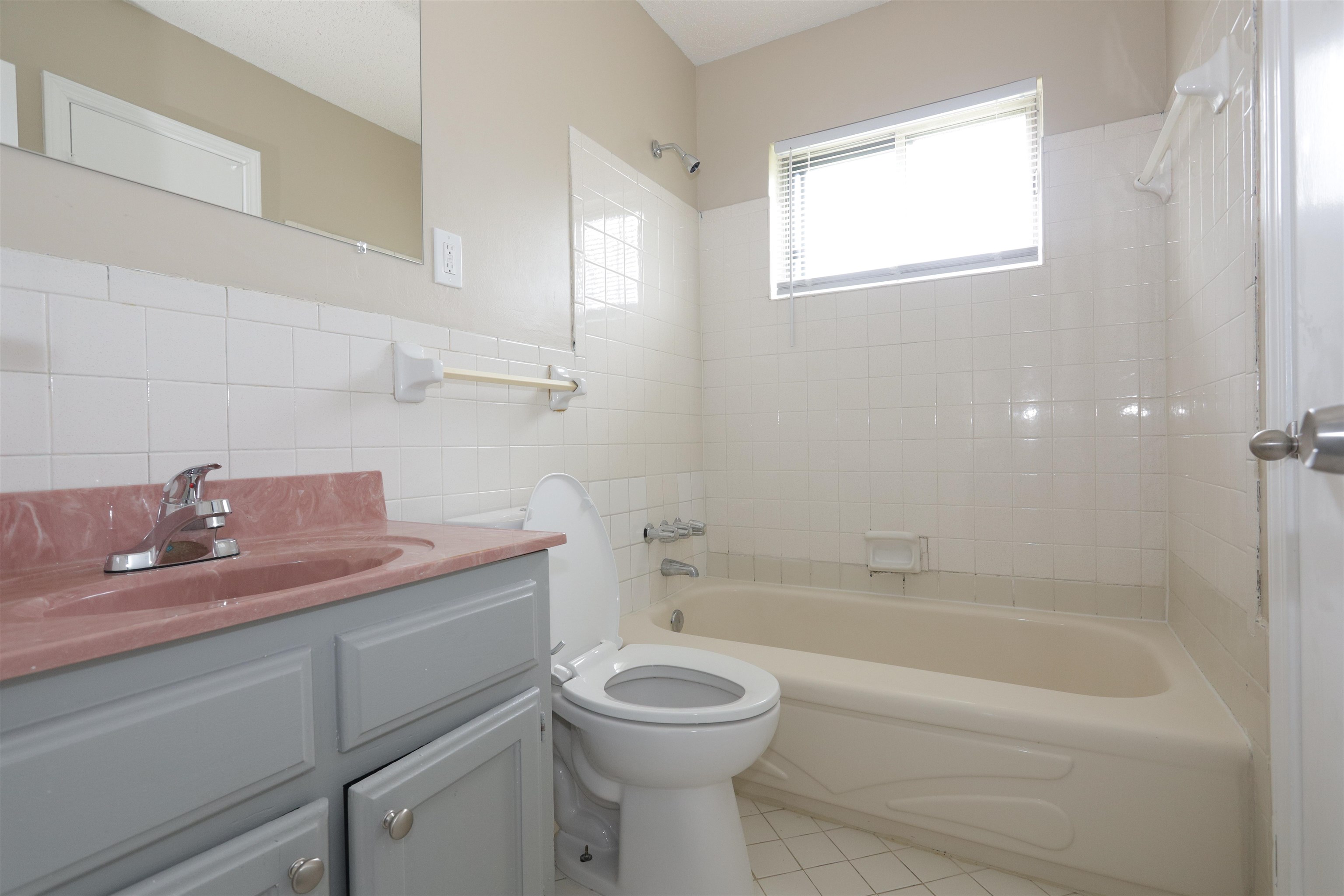 5142 Fairley Road Memphis, TN 38109 - Photo 8 of 13 a bathroom with a granite countertop toilet a sink and bathtub