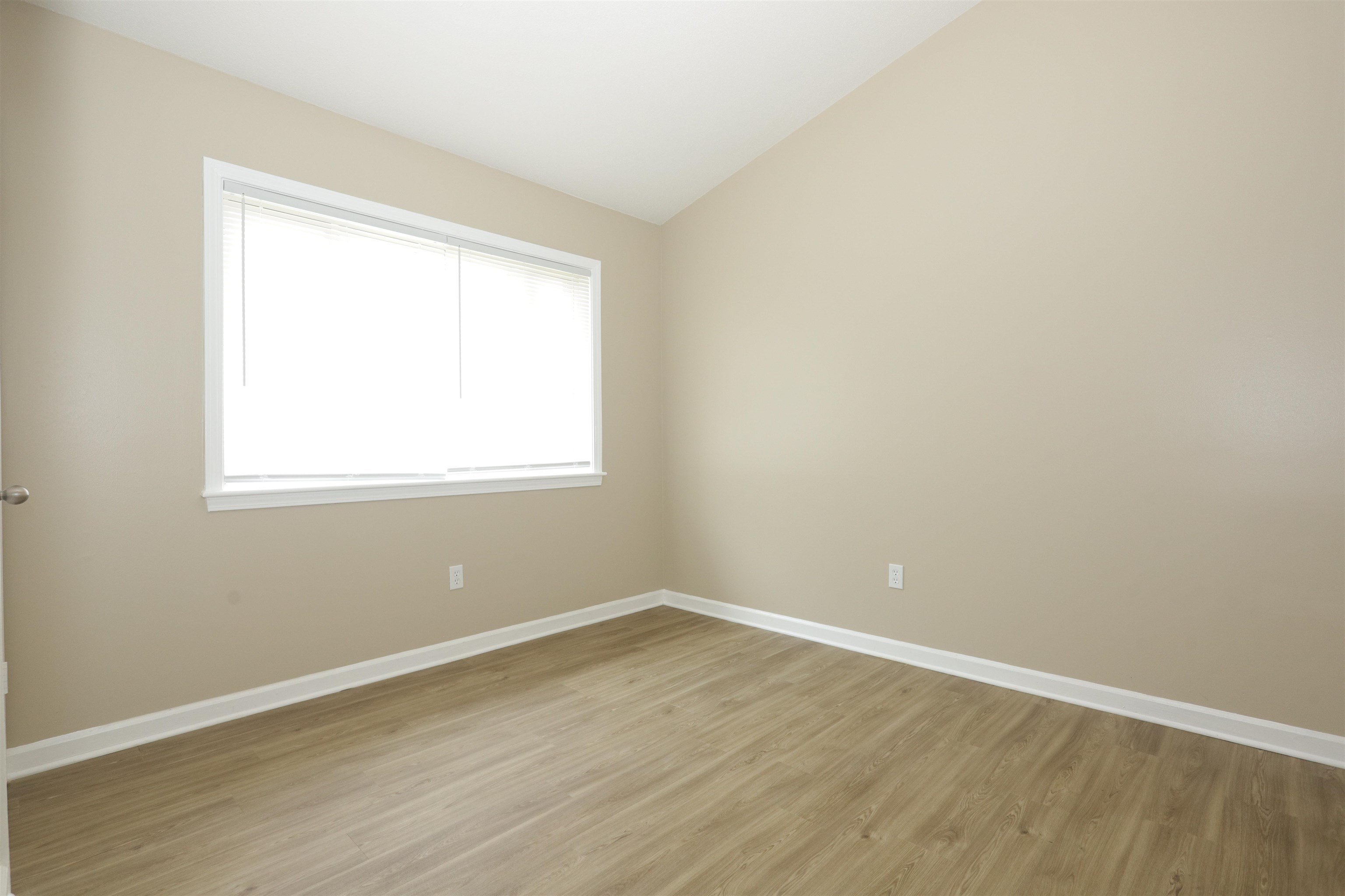 5142 Fairley Road Memphis, TN 38109 - Photo 9 of 13 an empty room with wooden floor and a window