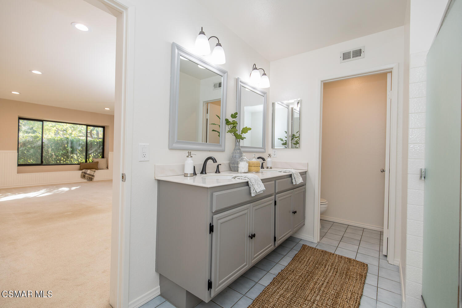12617 Crystal Ranch Road Moorpark, CA 93021 - Photo 12 of 34 a spacious bathroom with a double vanity sink a mirror and a bathtub