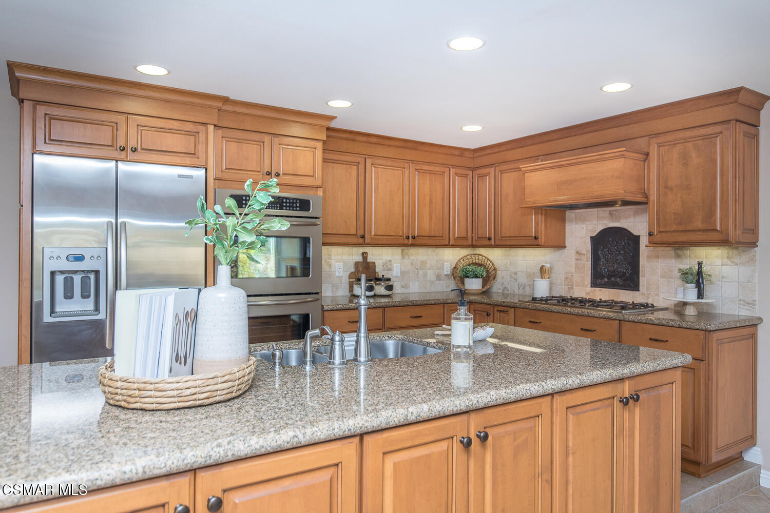 12617 Crystal Ranch Road Moorpark, CA 93021 - Photo 17 of 34 a kitchen with stainless steel appliances granite countertop a sink a stove and cabinets