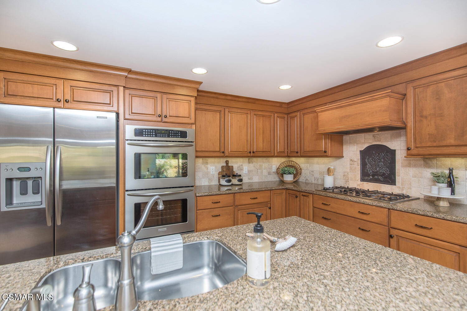 12617 Crystal Ranch Road Moorpark, CA 93021 - Photo 18 of 34 a kitchen with stainless steel appliances granite countertop a sink refrigerator stove and microwave