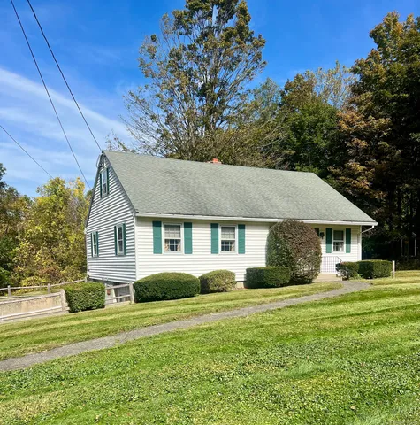 a front view of house with yard and green space