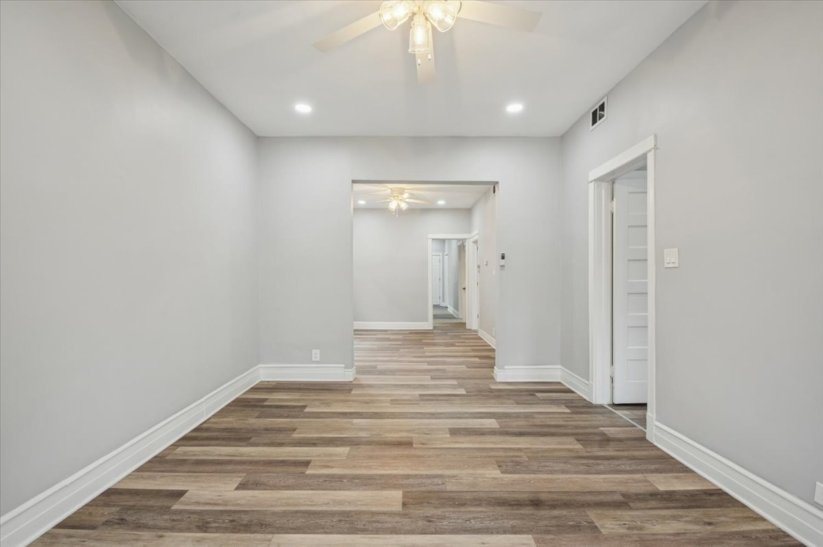 6338 South Ada Street, Unit 2 Chicago, IL 60636 - Photo 4 of 12 a view of a hallway with wooden floor and a chandelier