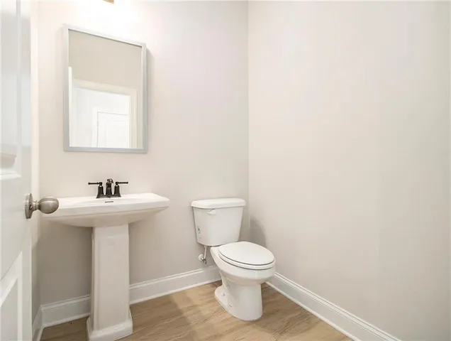 a white toilet sitting next to a bathroom sink