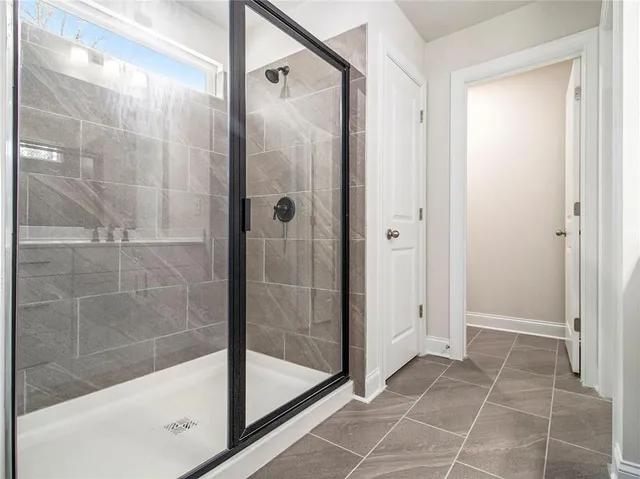 a bathroom with a glass shower door