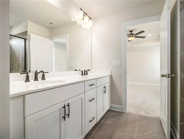 a bathroom with a double vanity sink and mirror