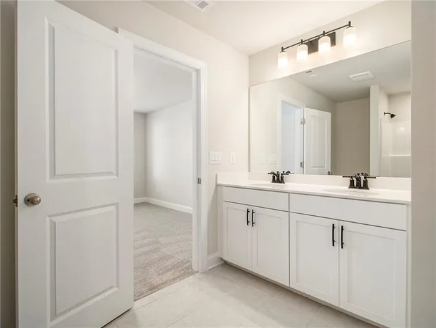 a bathroom with a double vanity sink and mirror