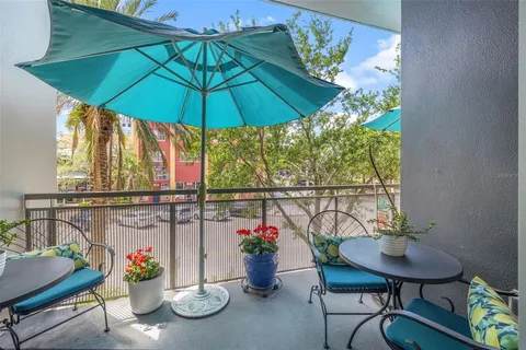 a view of balcony with furniture and umbrella