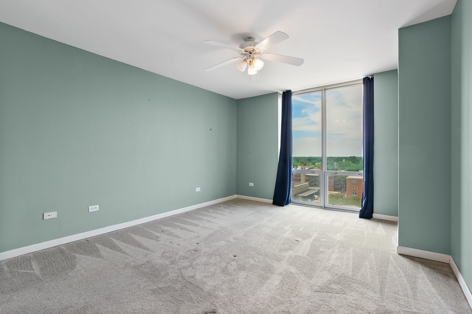 1640 Maple Avenue, Unit 903 Evanston, IL 60201 - Photo 11 of 24 an empty room with windows and ceiling fan