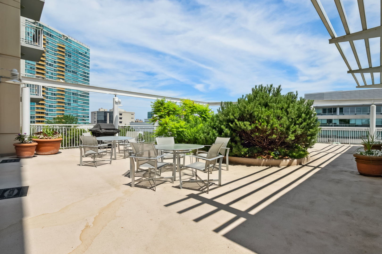 1640 Maple Avenue, Unit 903 Evanston, IL 60201 - Photo 18 of 24 a view of a patio with a table and chairs and potted plants