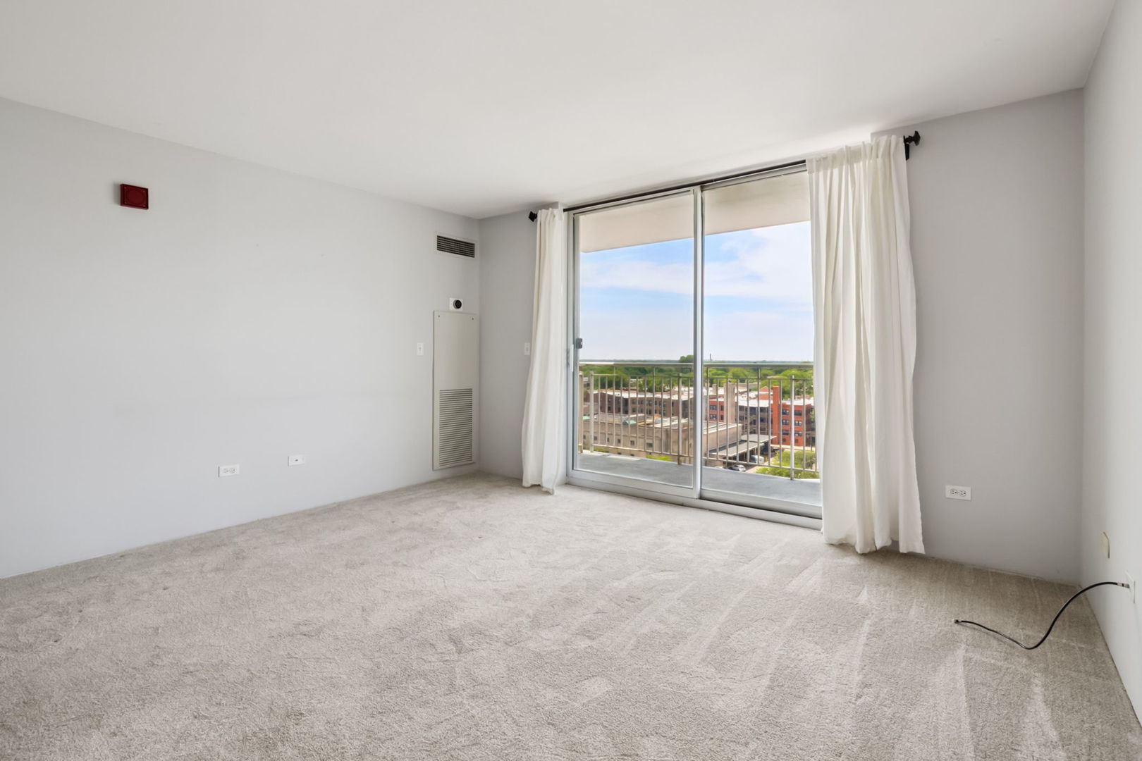 1640 Maple Avenue, Unit 903 Evanston, IL 60201 - Photo 3 of 24 a view of an empty room with a sliding door