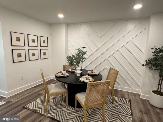 a dining room with furniture and wooden floor