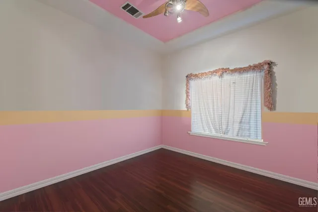 a room with wooden floor and windows