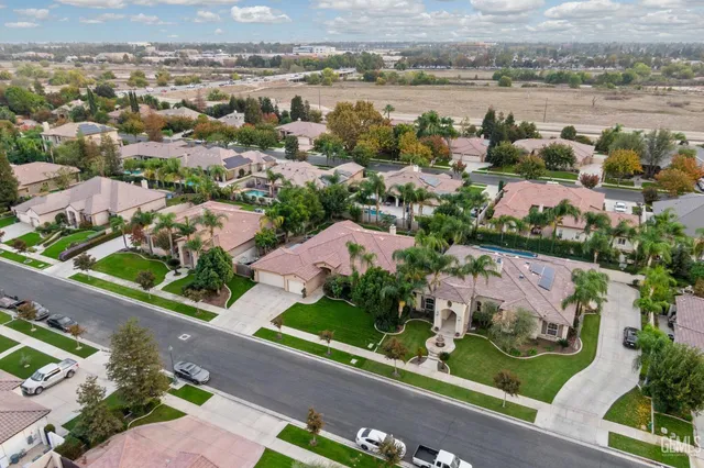 an aerial view of lake and residential houses with outdoor space