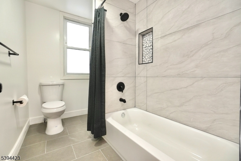 282 Woodside Avenue, Unit 1 Newark, NJ 07104 - Photo 4 of 18 a bathroom with a toilet sink and shower