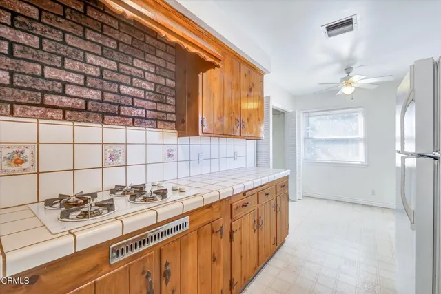 a kitchen with a sink stove and refrigerator