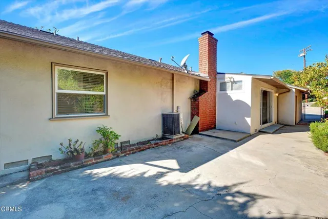 a view of a yard with potted plants