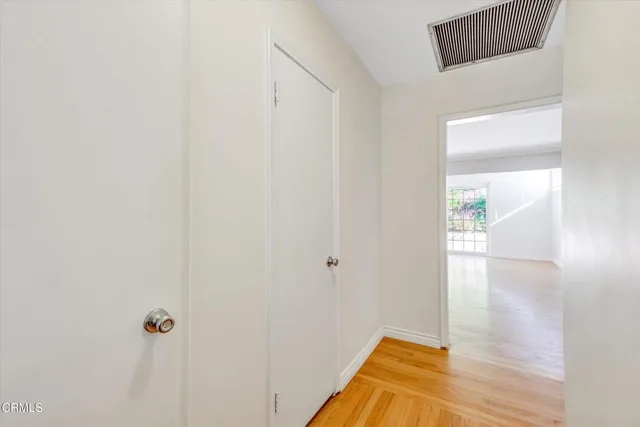 a view of a hallway with wooden floor