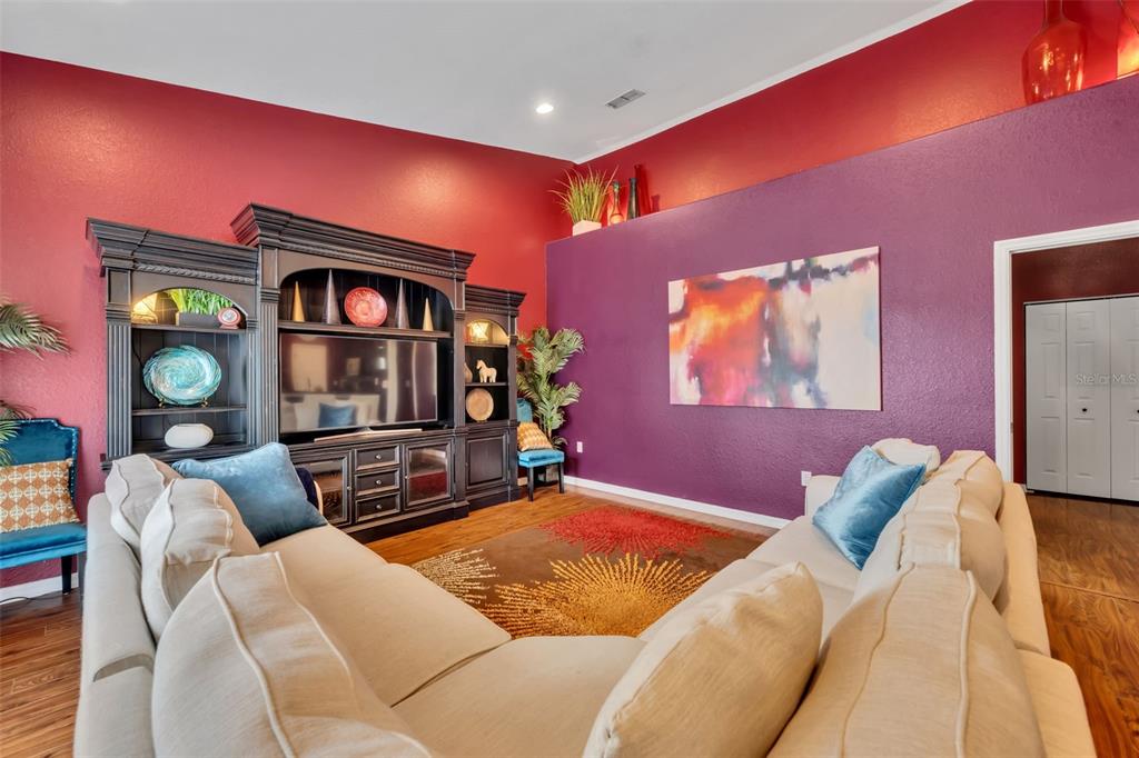 4946 Northeast 124th Road Oxford, FL 34484 - Photo 23 of 69 a bedroom with furniture and a flat screen tv