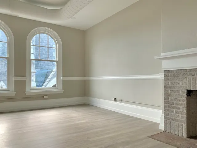 an empty room with windows and entrance