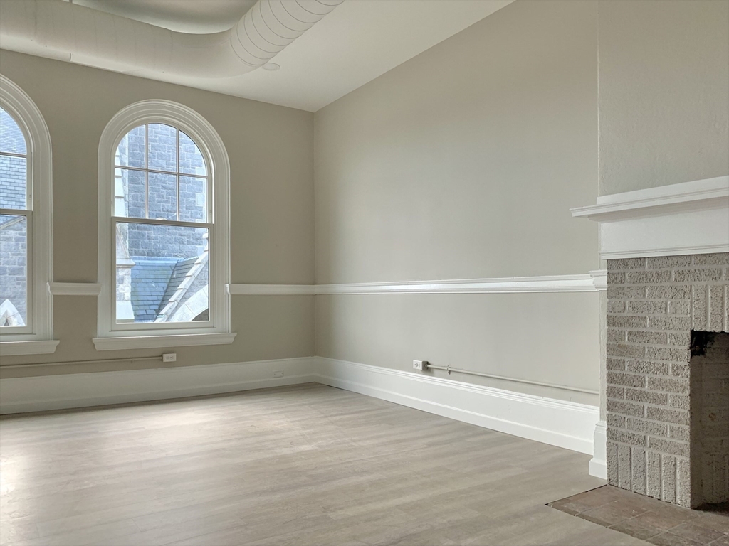 6 Chatham Street, Unit 301 Worcester, MA 01608 - Photo 2 of 7 an empty room with windows and entrance