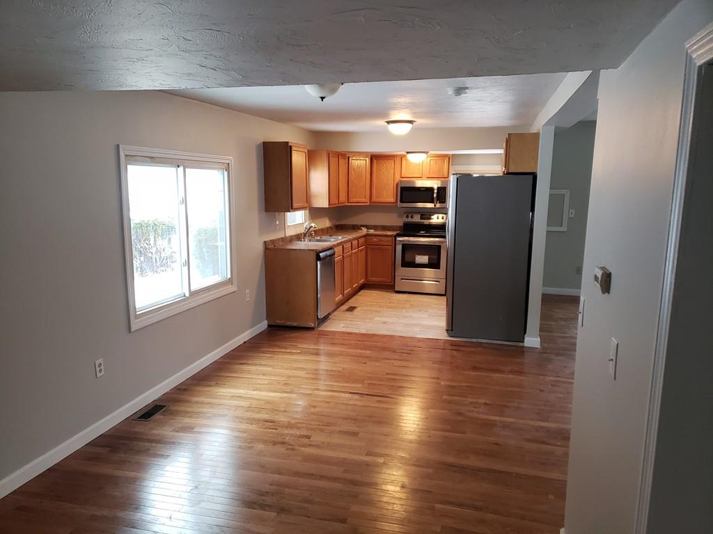 59 Old Poor Farm Road Ware, MA 01082 - Photo 13 of 15 a kitchen with stainless steel appliances granite countertop a refrigerator and a stove top oven
