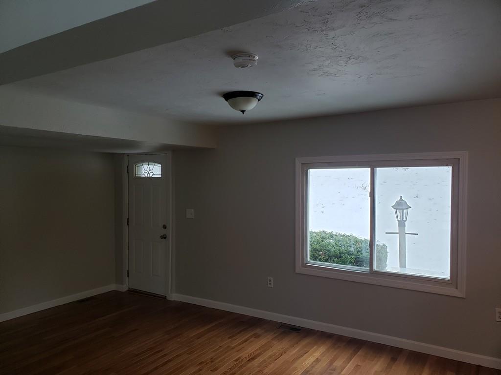 59 Old Poor Farm Road Ware, MA 01082 - Photo 14 of 15 an empty room with wooden floor and windows