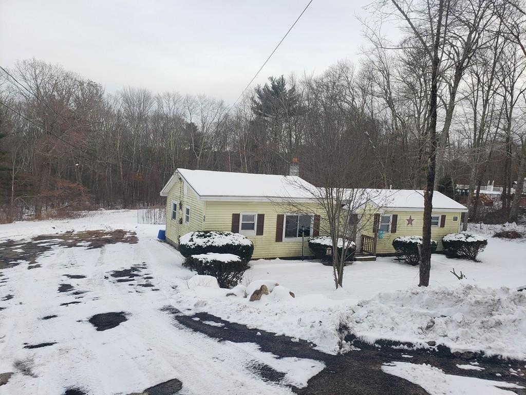 59 Old Poor Farm Road Ware, MA 01082 - Photo 2 of 15 a view of a blue house with snow on the road