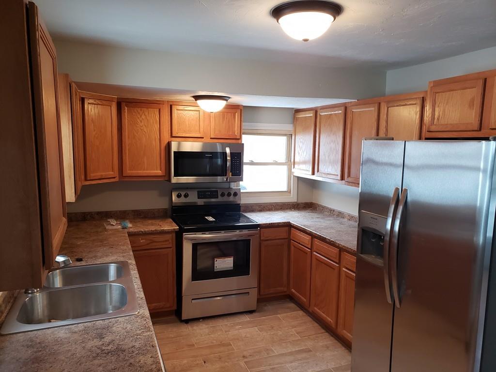 59 Old Poor Farm Road Ware, MA 01082 - Photo 6 of 15 a kitchen with stainless steel appliances granite countertop a stove a sink and a refrigerator