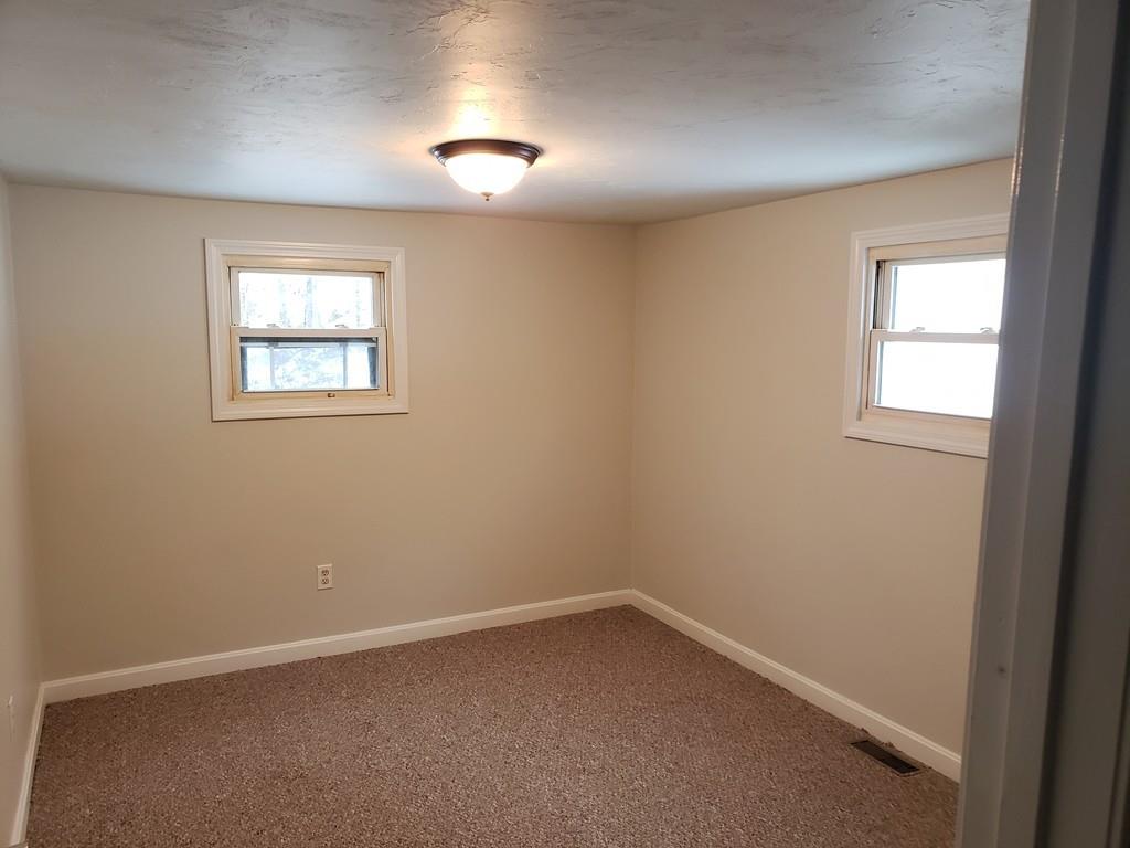59 Old Poor Farm Road Ware, MA 01082 - Photo 9 of 15 an empty room with a window
